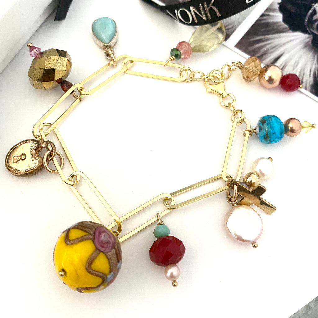Leoni & Vonk charm bracelet featuring brightly coloured charms on a white background.