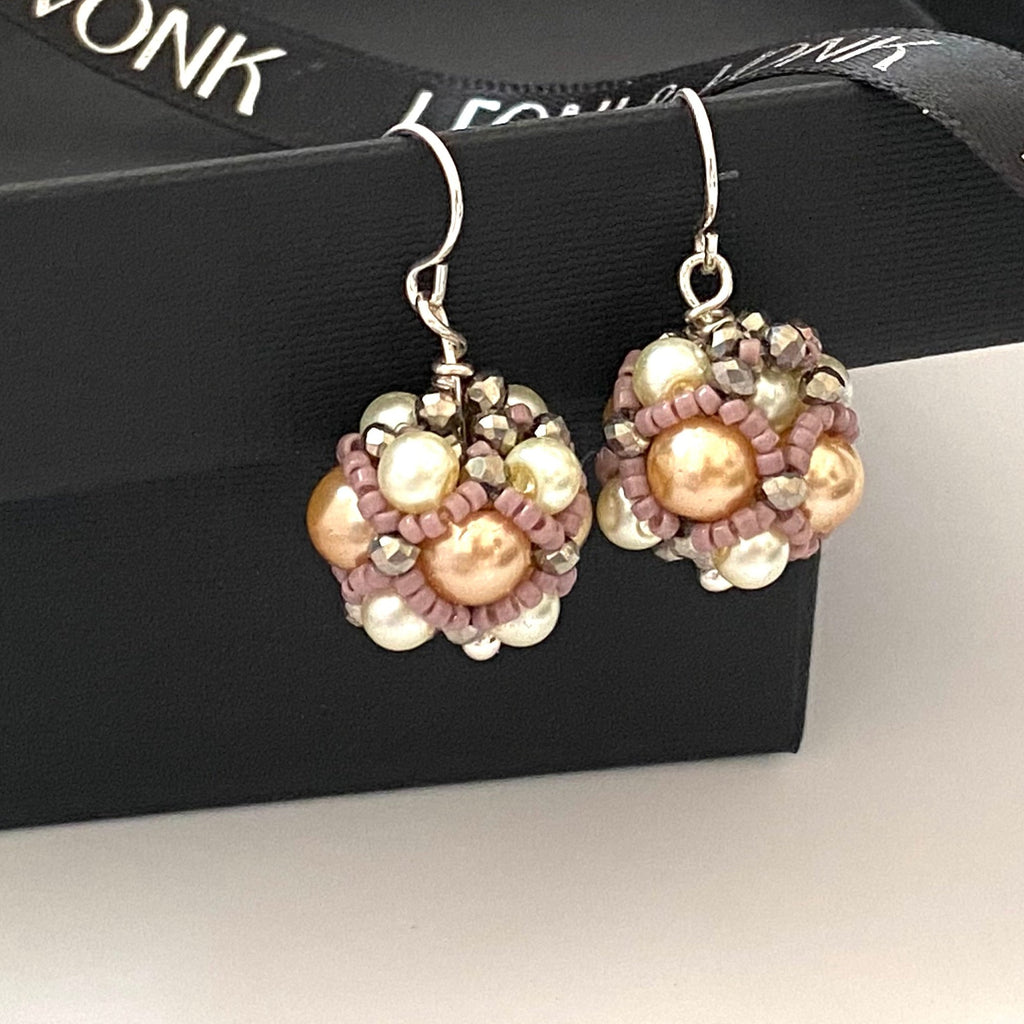 Leoni & Vonk apricot and crystal pearl cluster earrings on a black box and with Leoni & Vonk ribbon.