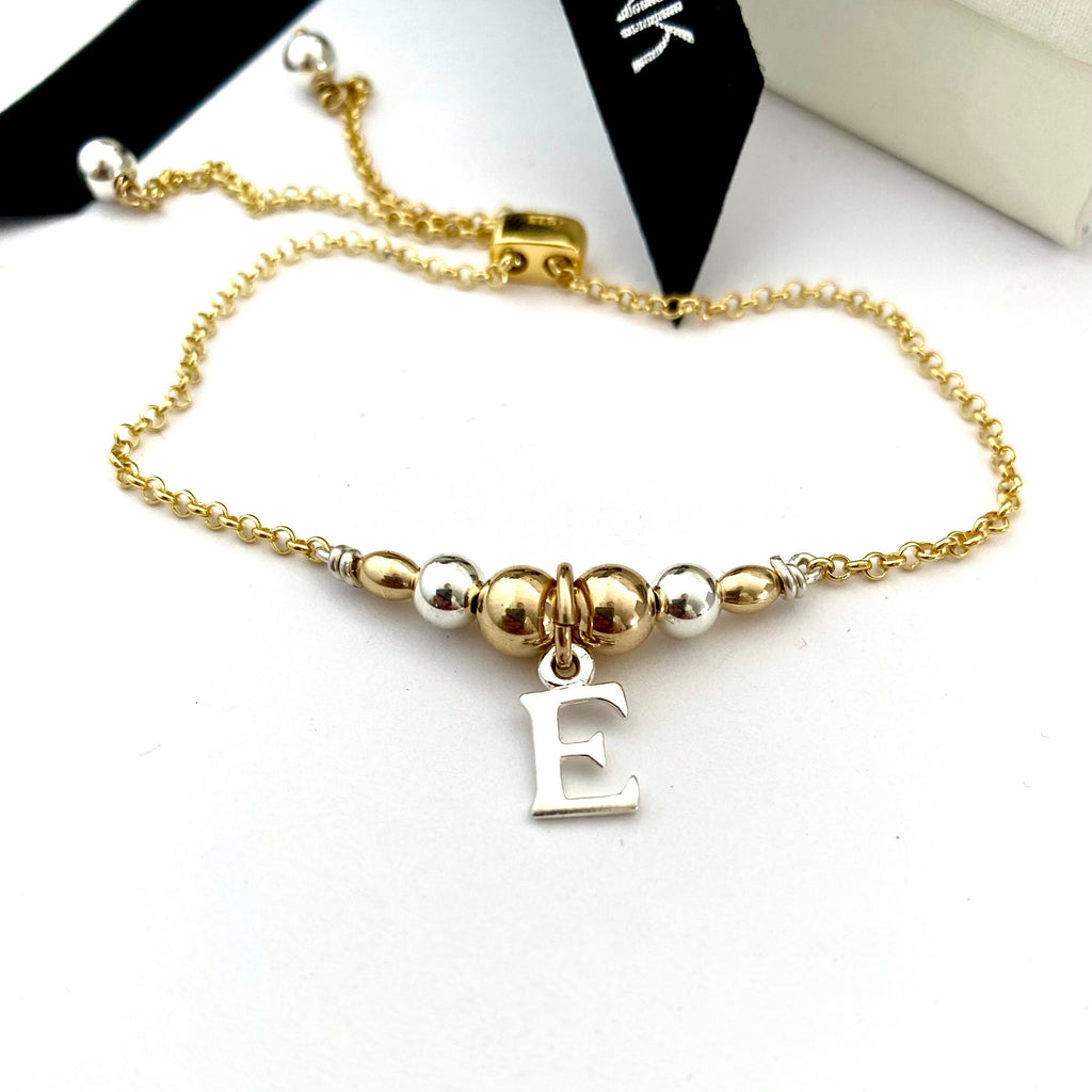 Leoni & Vonk gold fill and sterling silver friendship bracelet with the initial E charm with Leoni & Vonk ribbon