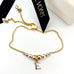 Leoni & Vonk gold fill and sterling silver friendship bracelet with the initial E charm with Leoni & Vonk ribbon